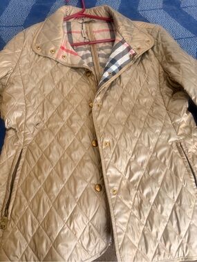 Burberry Quilted Champagne Puffer Jacket with Signature Check Linings.